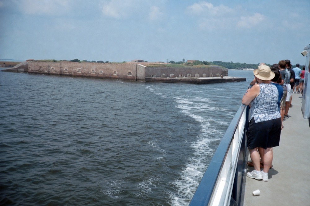 A narrated tour boat passing Fort Sumter in Charleston Harbor, no text, no logos, no people