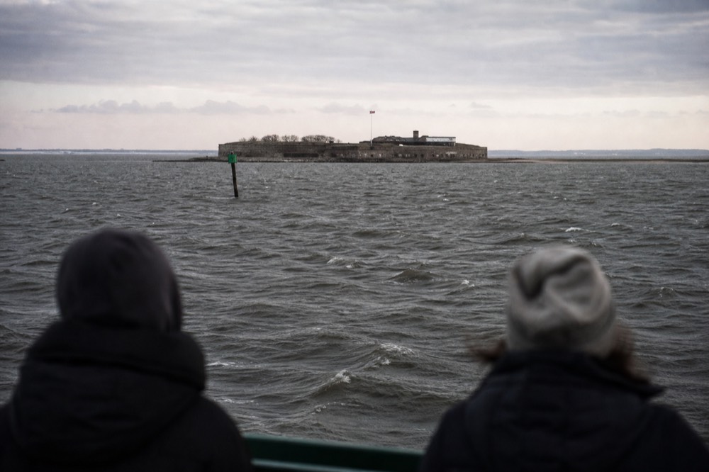 Fort Sumter seen from the water across a wide harbor channel, no text, no logos, no people.