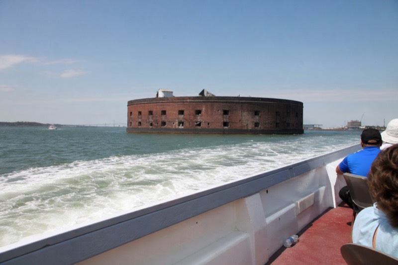 Round harbor fort under bright midday sun seen from a Charleston historic harbor cruise boat