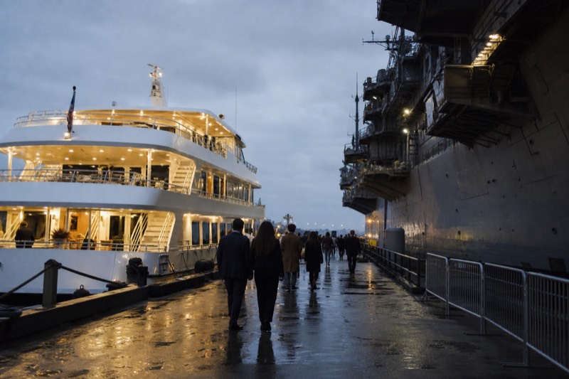 Charleston luxury harbor dinner cruise boat lit warmly at its Patriots Point mooring during evening departure